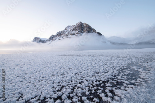 winter mountain landscape with snow mountains and white clouds and hoarfrost 