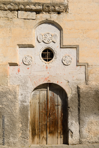 Old weathered door of stone house in Mustafapasa village Cappadocia Turkey photo