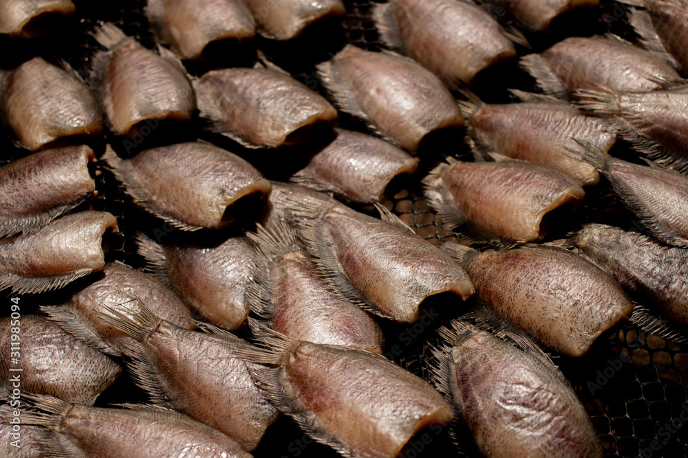 Preparing dried Trichopodus for cooking in Thai food style. This method is type of food preservation.