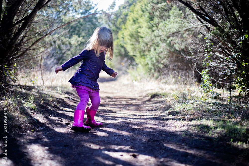 young girl in muddy boots on trail young girl in muddy boots on trail