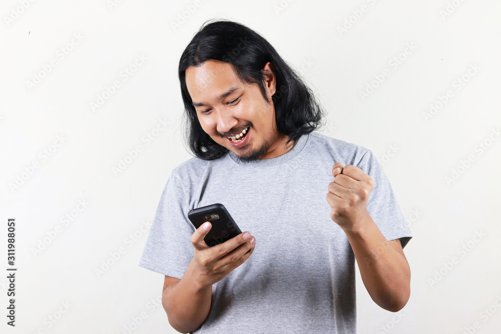 bearded man looks at smartphone and rejoicing on white background bearded man looks at smartphone and rejoicing on white background