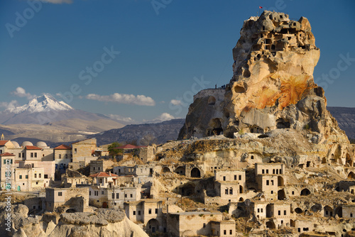 Mount Erciyes and Ortasihar Castle with workers repairing fortress as a museum Cappadocia Turkey