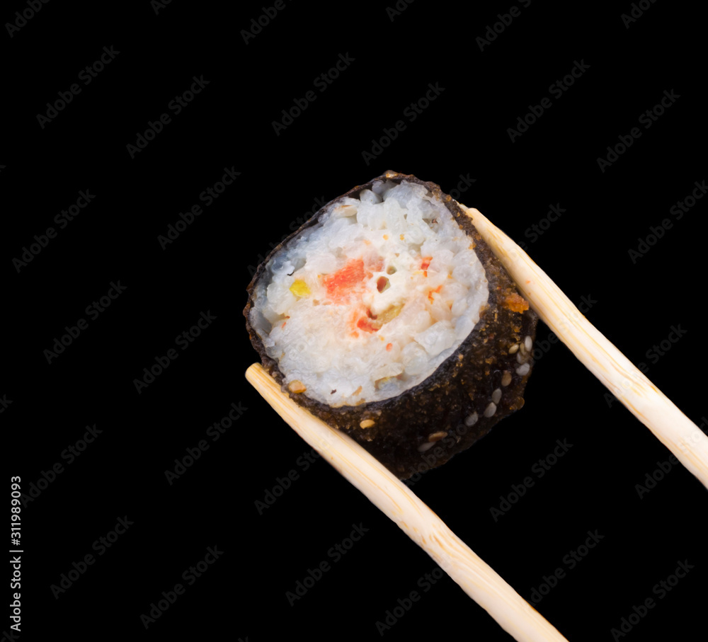warm sushi rolls on sticks on a black background warm sushi rolls on sticks on a black background