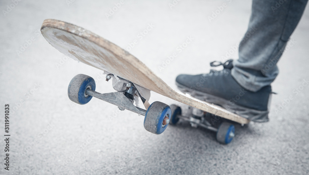 Fototapeta premium Boy rides on skateboard in the asphalt.