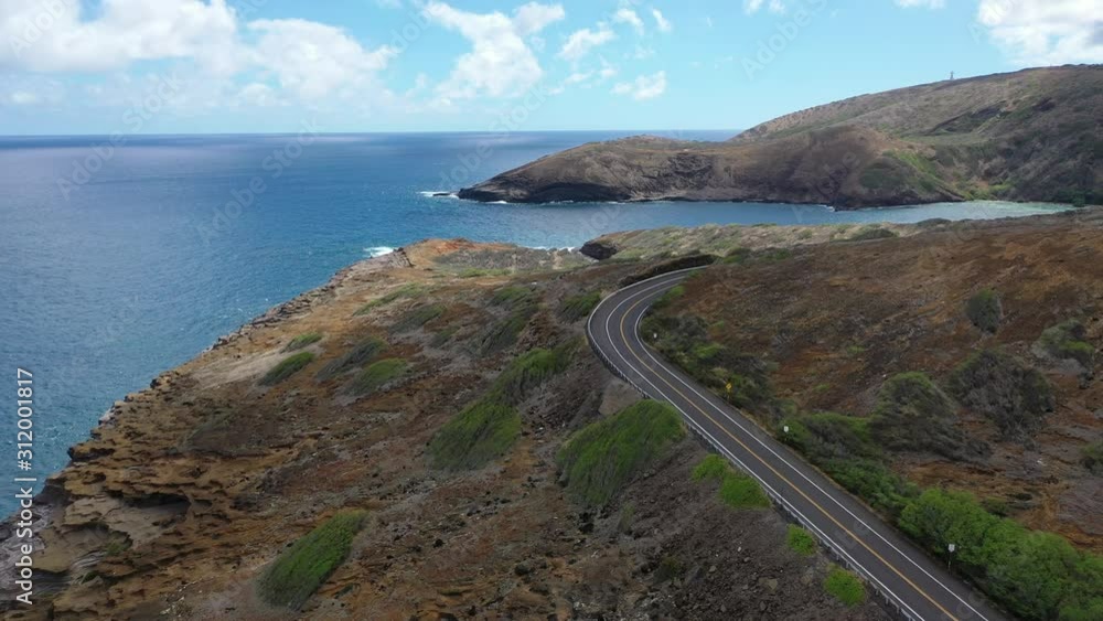 Aerial 4k view of island road, and tropical beach bay on clear sunny day Aerial 4k view of island road, and tropical beach bay on clear sunny day