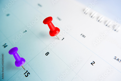 Thumbtack a date on calendar concept for important date, meeting reminder, planning for business, travel planning concept