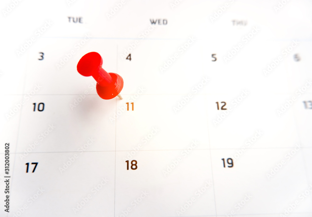 Thumbtack a date on calendar concept for important date, meeting reminder, planning for business, travel planning concept Thumbtack a date on calendar concept for important date, meeting reminder, planning for business, travel planning concept