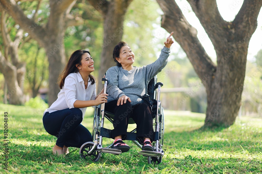 senior couple sitting on bench in the park senior couple sitting on bench in the park