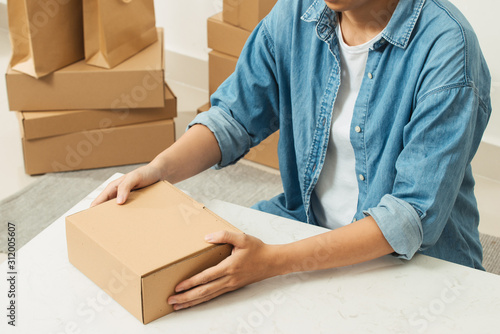 Woman with parcel box indoors