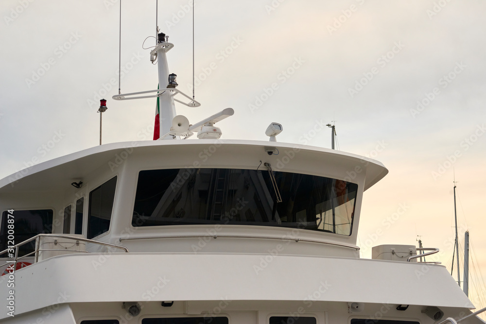 Naklejka premium detail of white ferry cockpit in a harbour