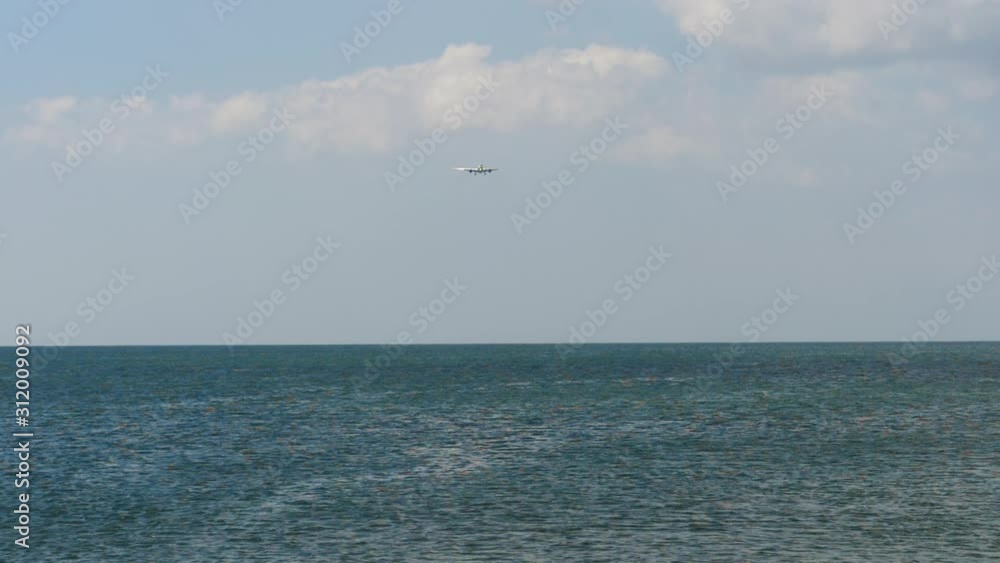 Airplane approaching over ocean Airplane approaching over ocean