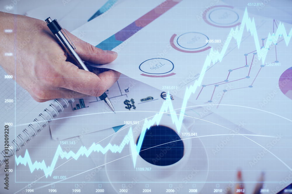 Multi exposure of man planing investment with stock market forex chart. Multi exposure of man planing investment with stock market forex chart.