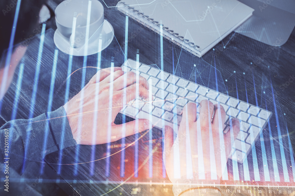 Multi exposure of graph with man typing on computer in office on background. Concept of hard work. Multi exposure of graph with man typing on computer in office on background. Concept of hard work.
