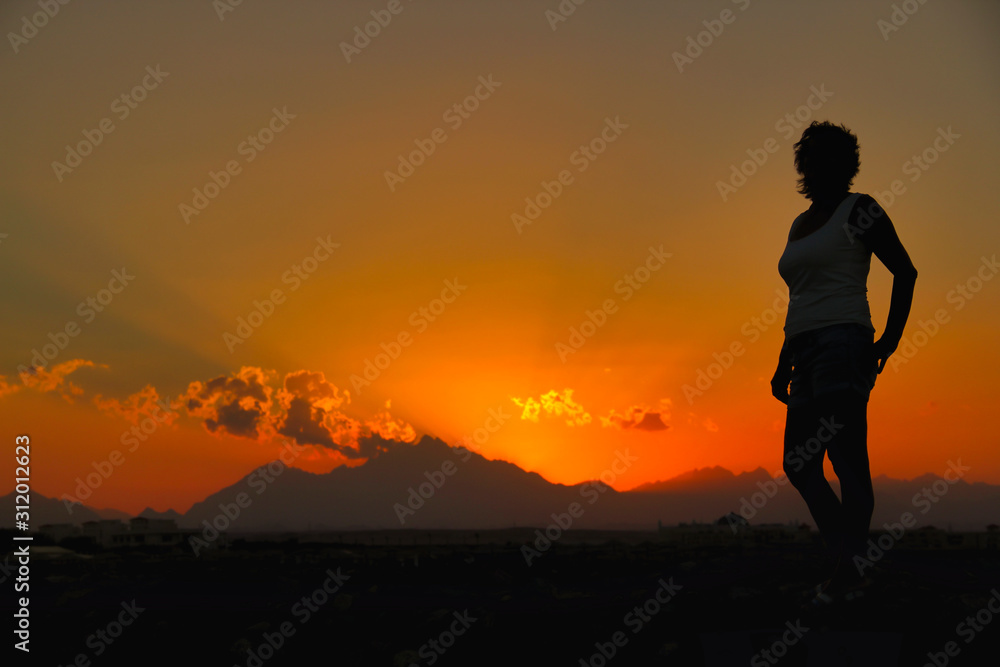 Woman on sunset background in Egypt