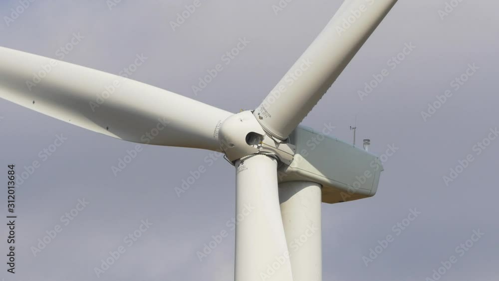 Close up of rotating wind turbine producing alternative energy on a sky Close up of rotating wind turbine producing alternative energy on a sky