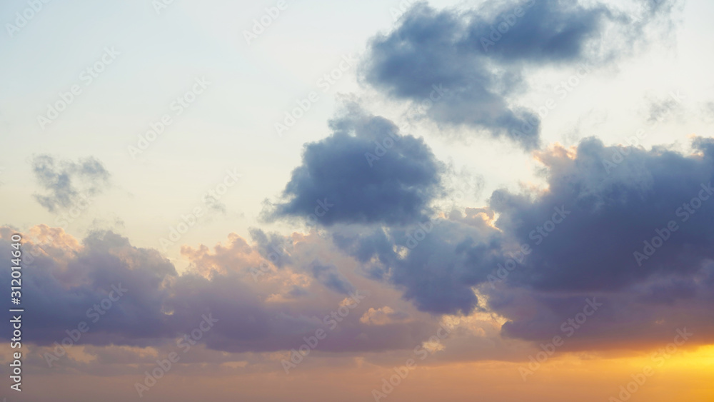 incredible orange blue sky with small clouds at sunset. background of bright sunset sky. incredible orange blue sky with small clouds at sunset. background of bright sunset sky.