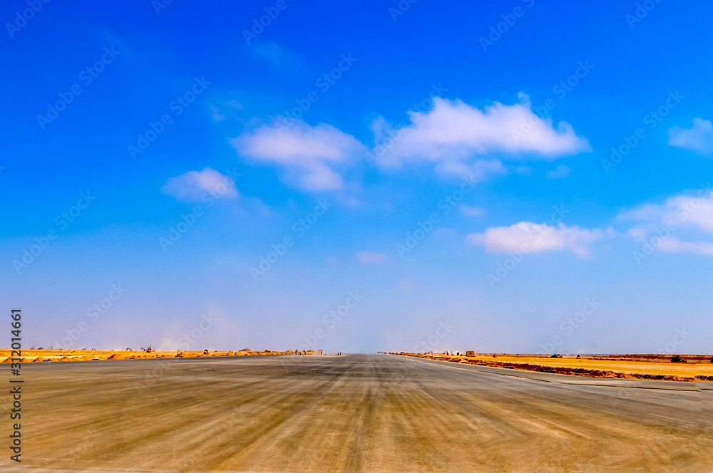 Under construction runway of the airport under blue sky
