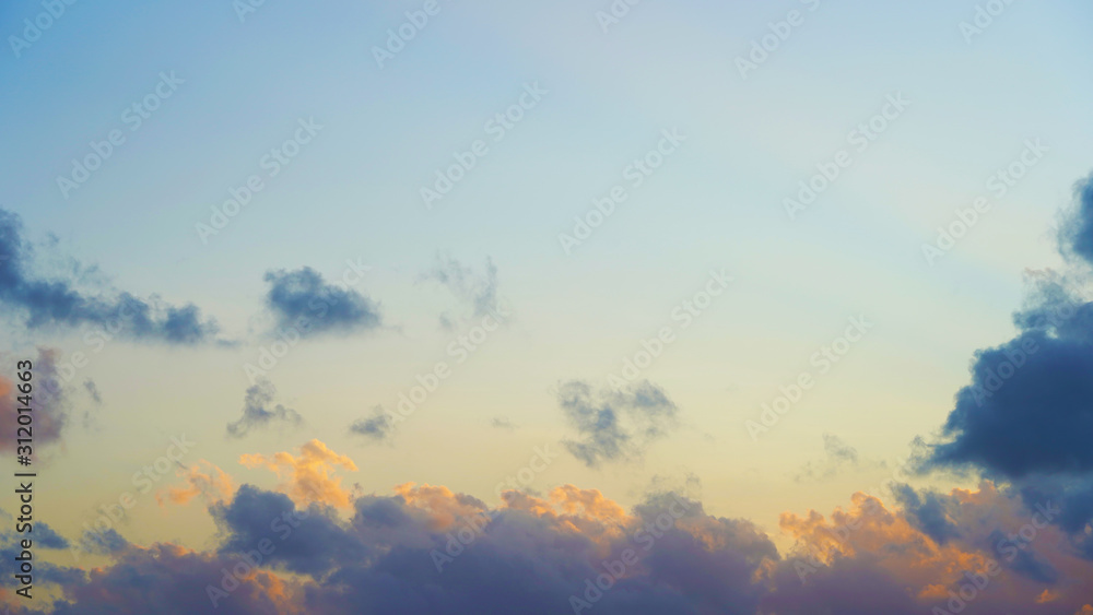 incredible orange blue sky with small clouds at sunset. background of bright sunset sky.
