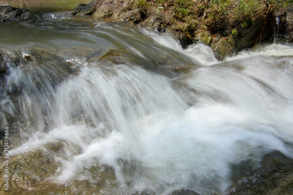 Obraz premium Slow motion waterfalls running at a stream