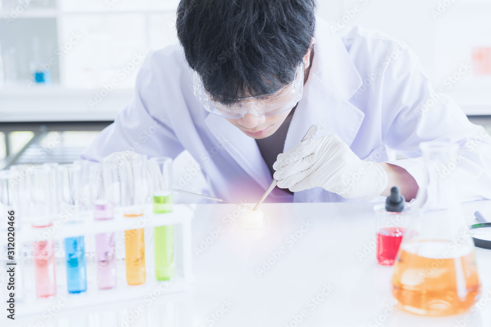 Male scientist collecting experimental samples.. Male scientist collecting experimental samples..