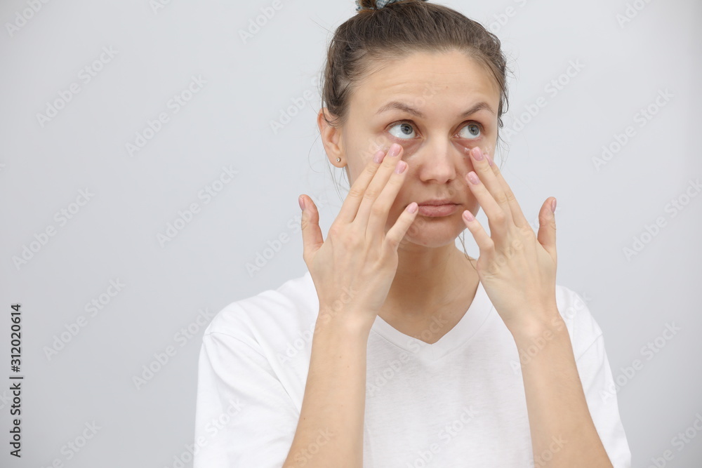 beautiful young woman cares for the skin around the eyes. Facial treatment. Cosmetology, beauty and spa. beautiful young woman cares for the skin around the eyes. Facial treatment. Cosmetology, beauty and spa.
