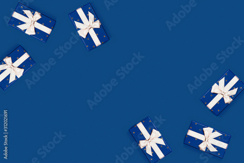 Classic blue background with 6 blue gift boxes. Flat lay, top view, place for the text.