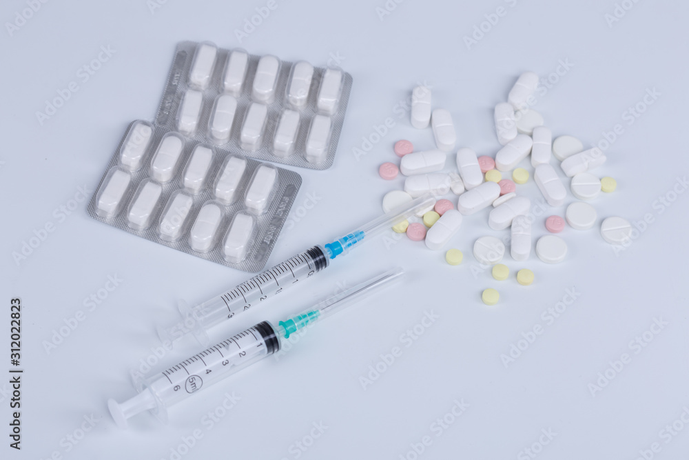 White pill, syringe and heroin on spoon. Drug addiction. White pill, syringe and heroin on spoon. Drug addiction.