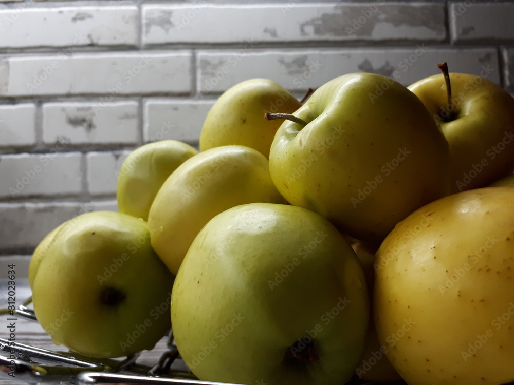 close-up of fruit, fresh juicy big yellow apples on an abstract surface close-up of fruit, fresh juicy big yellow apples on an abstract surface