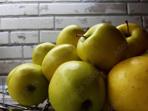 close-up of fruit  fresh juicy big yellow apples on an abstract surface