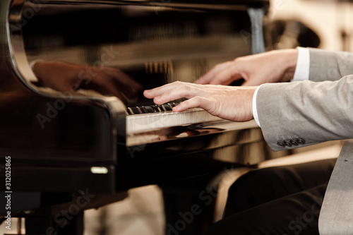 Closeup of the hand of a musician playing the piano