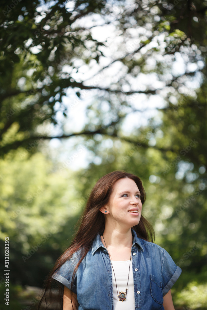 Young smiling brunette woman walking outdoors Young smiling brunette woman walking outdoors