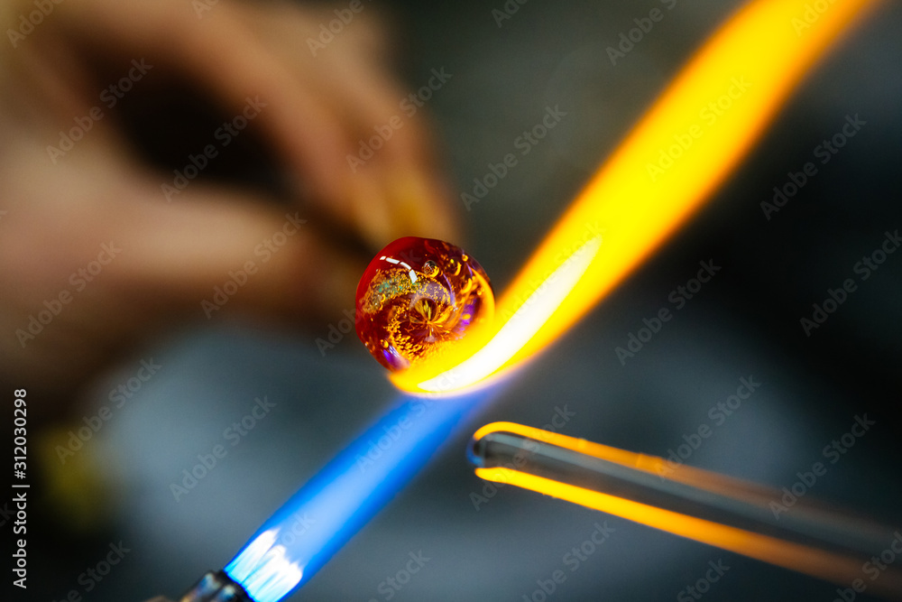 Close-up of glass bead melting in gas-burner fire
