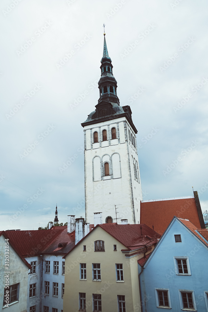 Aerial cityscape with medieval old town, St. Olav's Baptist church and Tallinn city wall in the morning, Tallinn, Estonia. Medieval walled city in the early autumn in the Baltic Sea region in Northern Aerial cityscape with medieval old town, St. Olav's Baptist church and Tallinn city wall in the morning, Tallinn, Estonia. Medieval walled city in the early autumn in the Baltic Sea region in Northern