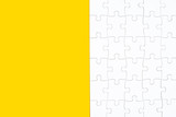 White jigsaw puzzle on yellow background with copy space