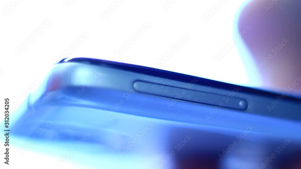 Close up of shiny mobile phone. Macro clip. Finger touching it, sliding, using it. Close up of shiny mobile phone. Macro clip. Finger touching it, sliding, using it.