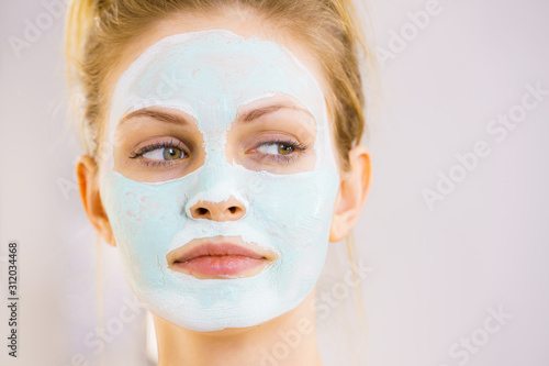 Girl with white green mud mask on face