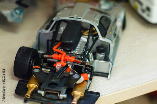Toy racing car. Model of Mercedes car. Little toy auto inside. Auto repair abstract. Space for copy