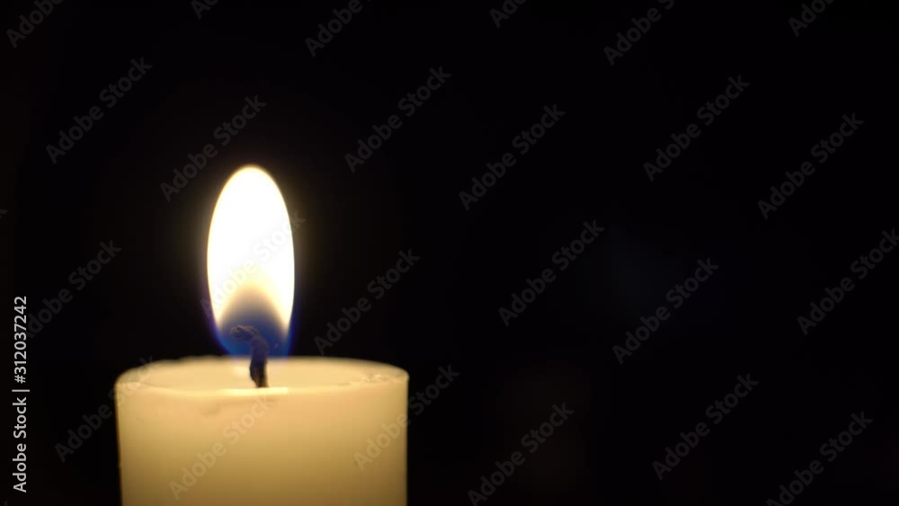 close-up of a bulging candle burns, the wind blows and the candle goes out in the dark. close-up of a bulging candle burns, the wind blows and the candle goes out in the dark.