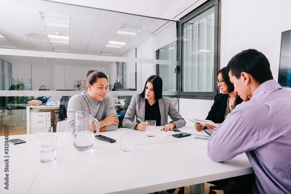 Group of office workers at a meeting around the boss Group of office workers at a meeting around the boss