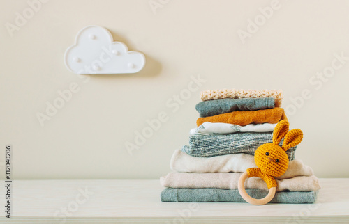 Organic cotton baby clothes on the shelf in the kids room