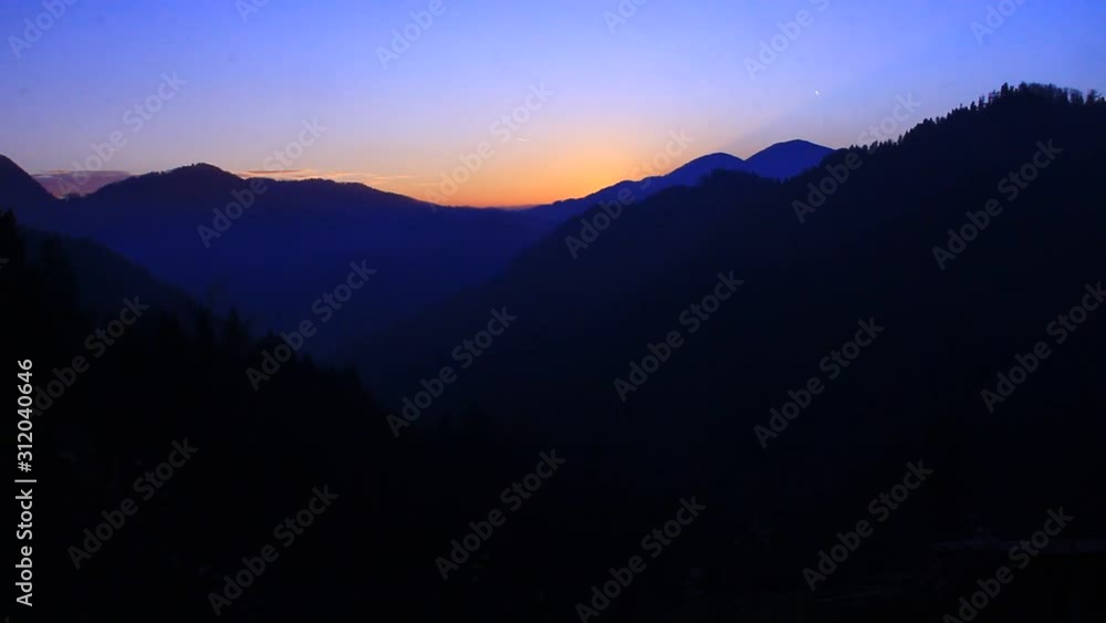 Sun going down in the mountains. Sunset with bold colors. Sun going down in the mountains. Sunset with bold colors.