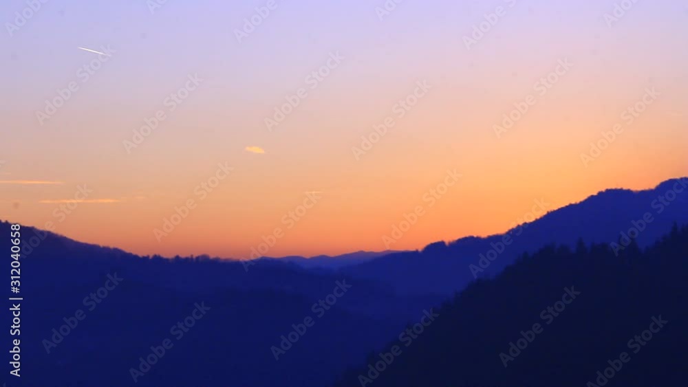 Sun going down in the mountains. Sunset with bold colors.