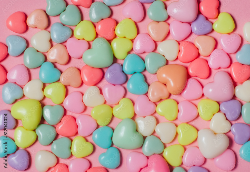 Background of colorful heart shape beads on pink background Background of colorful heart shape beads on pink background