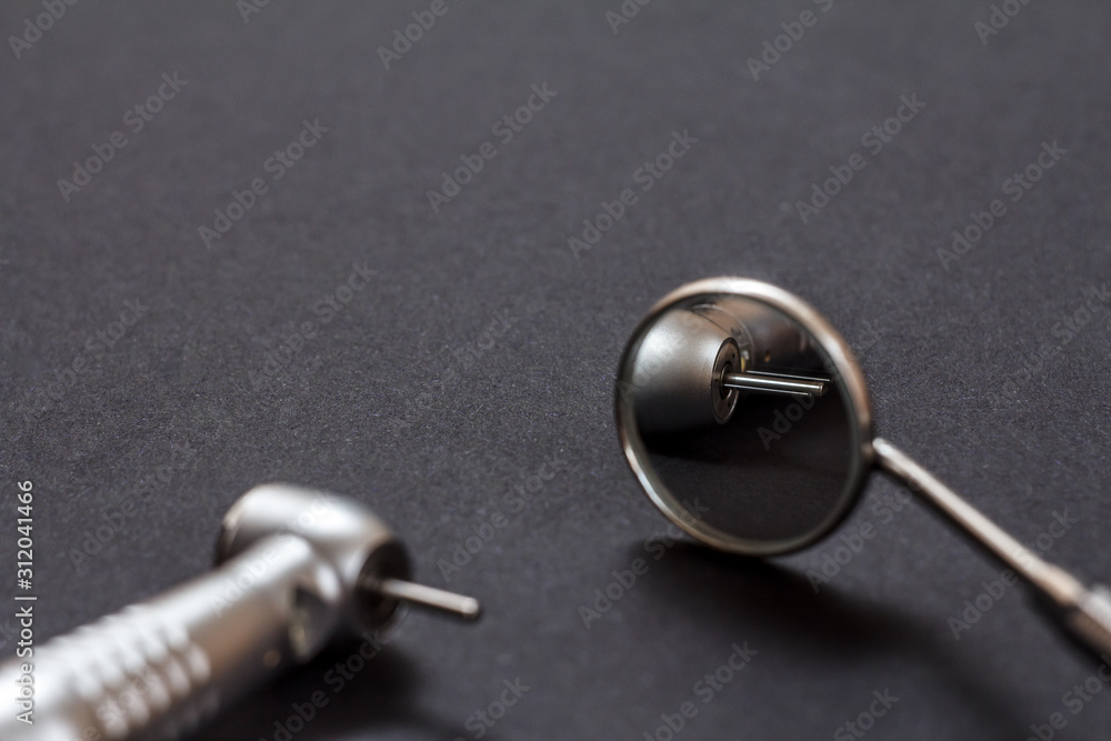 Dental instruments for teeth dental care on black background Dental instruments for teeth dental care on black background