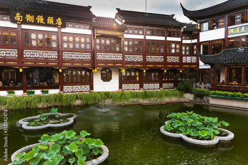 Beautiful, traditional red buildings in Yuyuan Old Street in Shanghai, China, by the water
