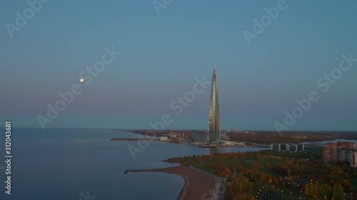 Lakhta Center. Glowing skyscraper on the seashore. Evening drone shooting.