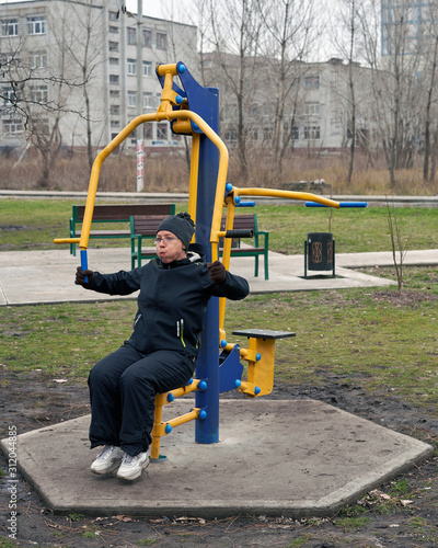 A woman in the early morning is engaged in street simulators.