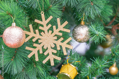 Beautiful Christmas star hanging from a decorated Christmas tree