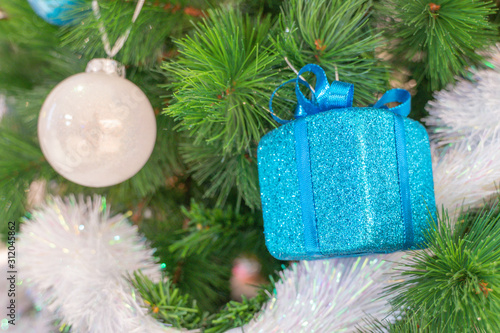 Beautiful Christmas gift boxes hanging from a decorated Christmas tree
