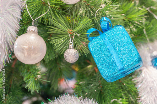 Beautiful Christmas gift boxes hanging from a decorated Christmas tree